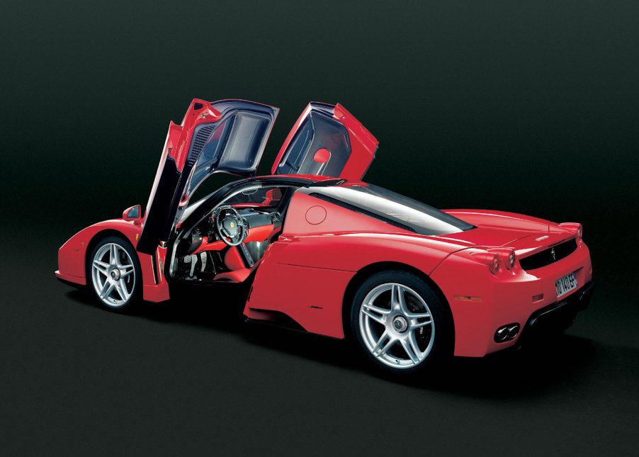 A digital image of a Ferrari Enzo in a black studio.