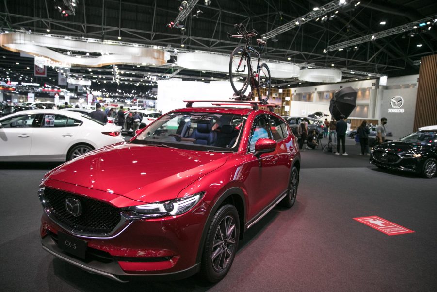 A red Mazda Cx-5 on display at an auto show