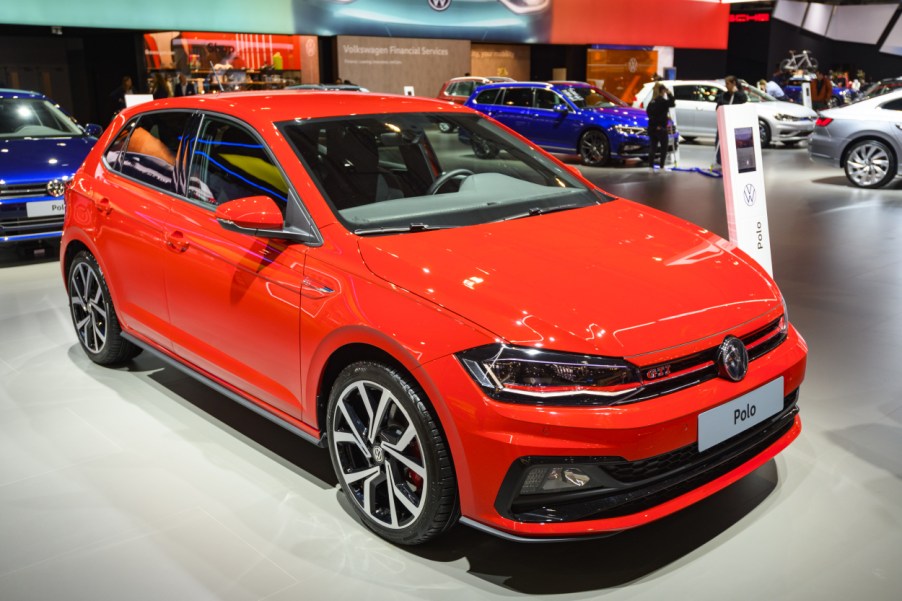 A red Volkswagen GTI on display at an auto show