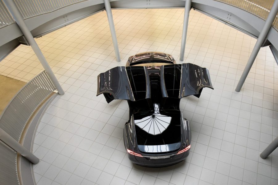 A black Tesla Model X with the falcon-wing doors open is on display in the new Tesla Service Center