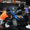 Workers prepare a royal-blue metallic 2012 Scion XD for display at the Chicago Auto Show on February 7, 2012, in Chicago, Illinois