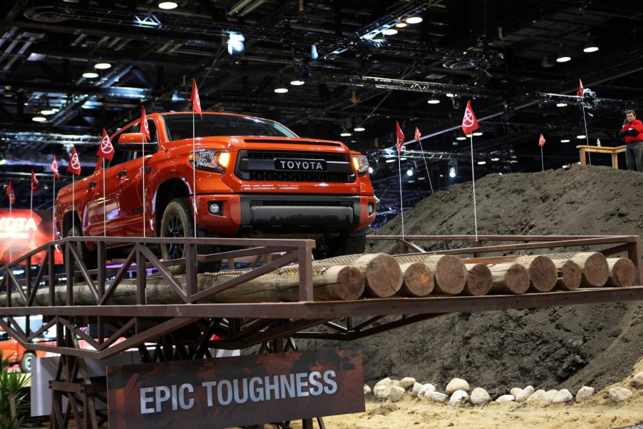 An orange 2015 Toyota Tundra traverses a road test