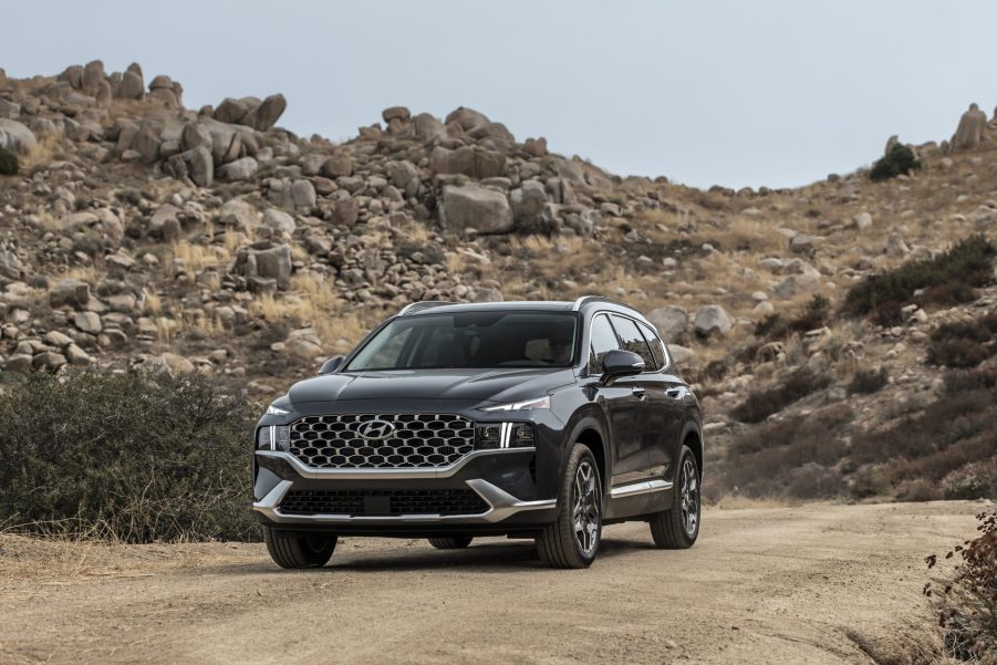 A black 2021 Hyundai Santa Fe Calligraphy parked in front of a rocky hill