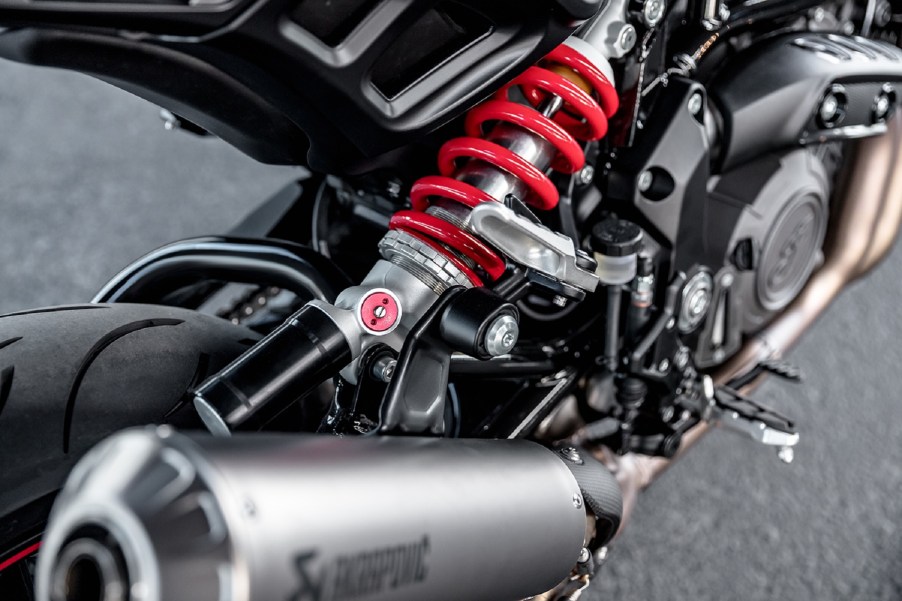 A close-up view of a black 2022 Indian FTR S's red-spring rear monoshock