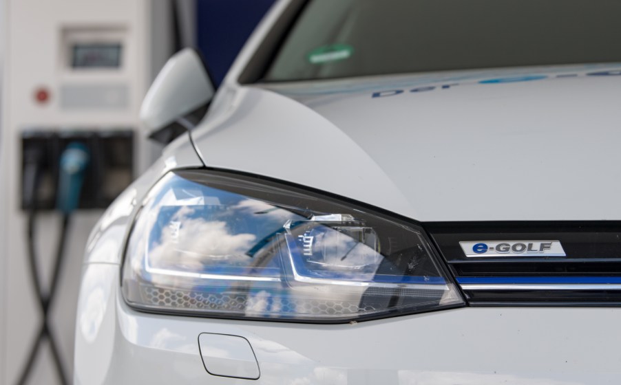 A Volkswagen electric vehicle charges at a charging station