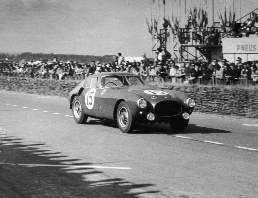 A black and white image of a Ferrari 375 MM out on a track.