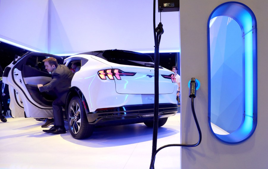 A white Ford Mustang Mach-E plugged in at the Chicago Auto Show