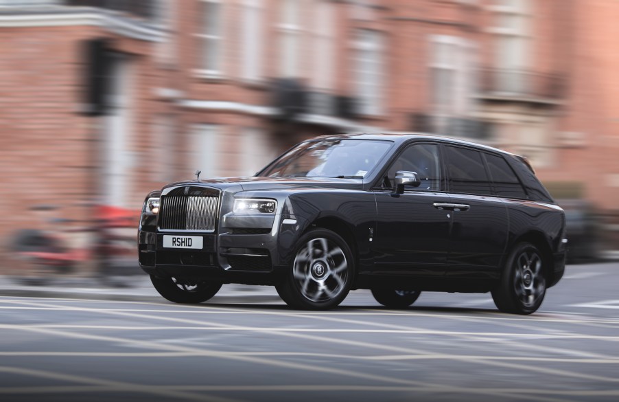 Rolls Royce Cullinan rolling down the street in the UK