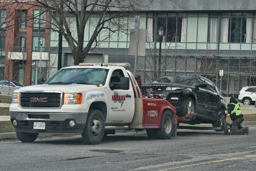 Tow truck towing a beat up Land Rover