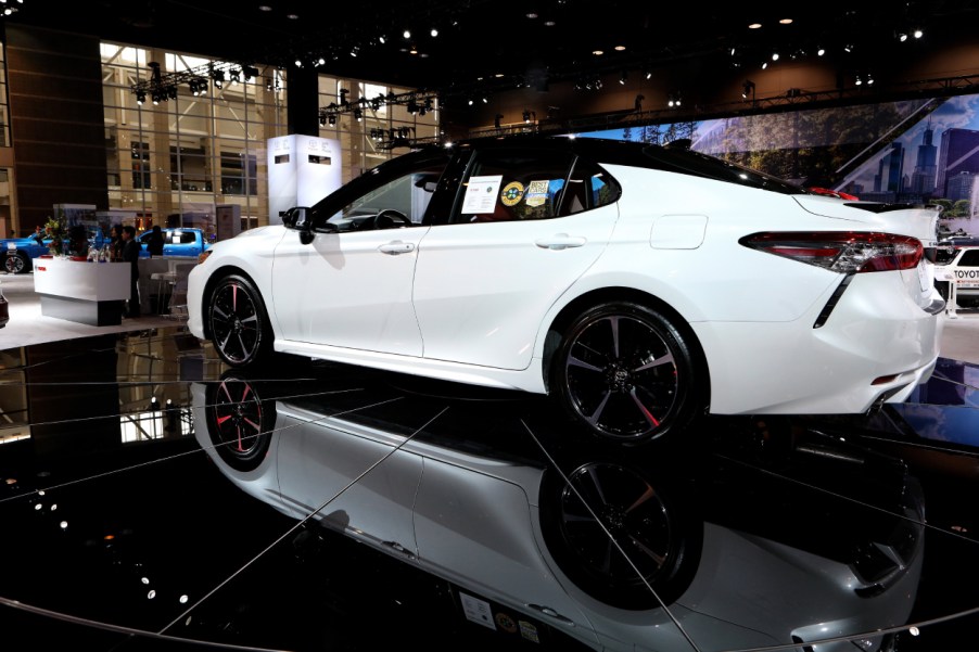 A white Toyota Avalon on display at an auto show