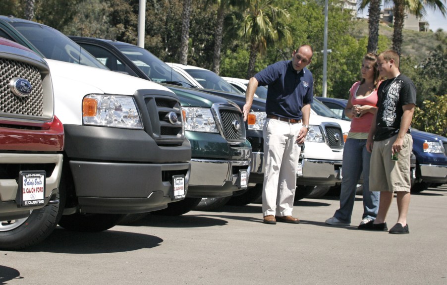 A group of Ford trucks for sale on a car lot