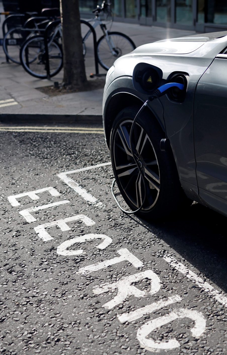 A charging cable is pictured plugged into a Volvo electric vehicle