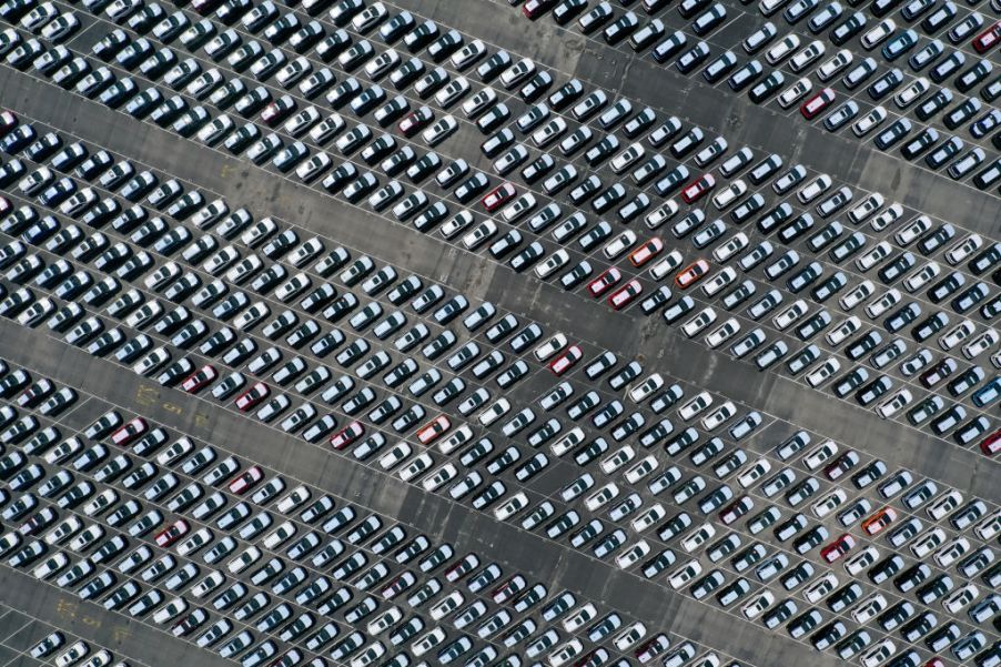 An areal view of a large parking lot filled with Subarus