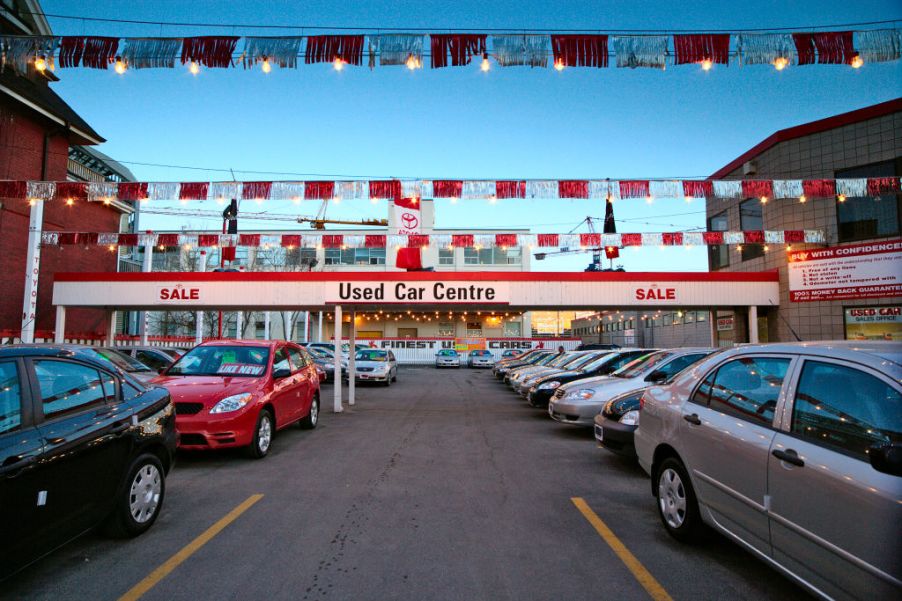 Cars parked in front of a used car dealership