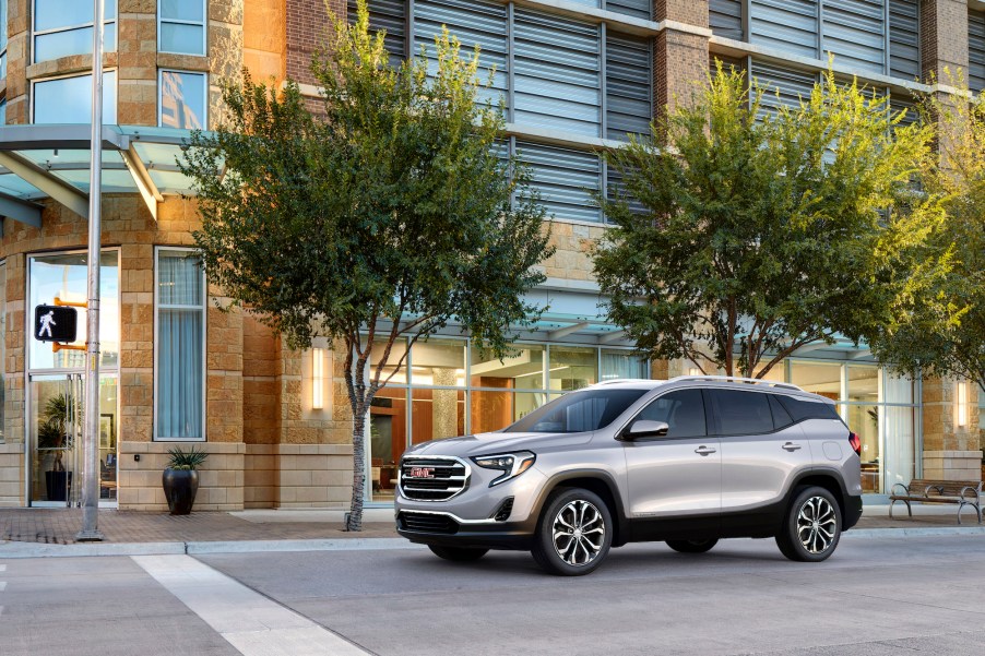 A silver 2021 GMC Terrain SLT crossover SUV on a city street