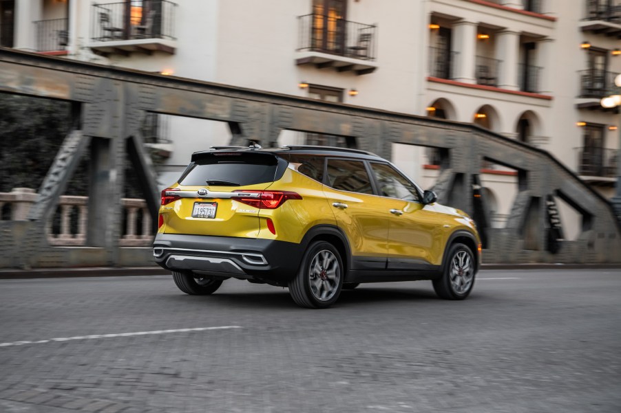 A yellow 2021 Kia Seltos parked on a city bridge