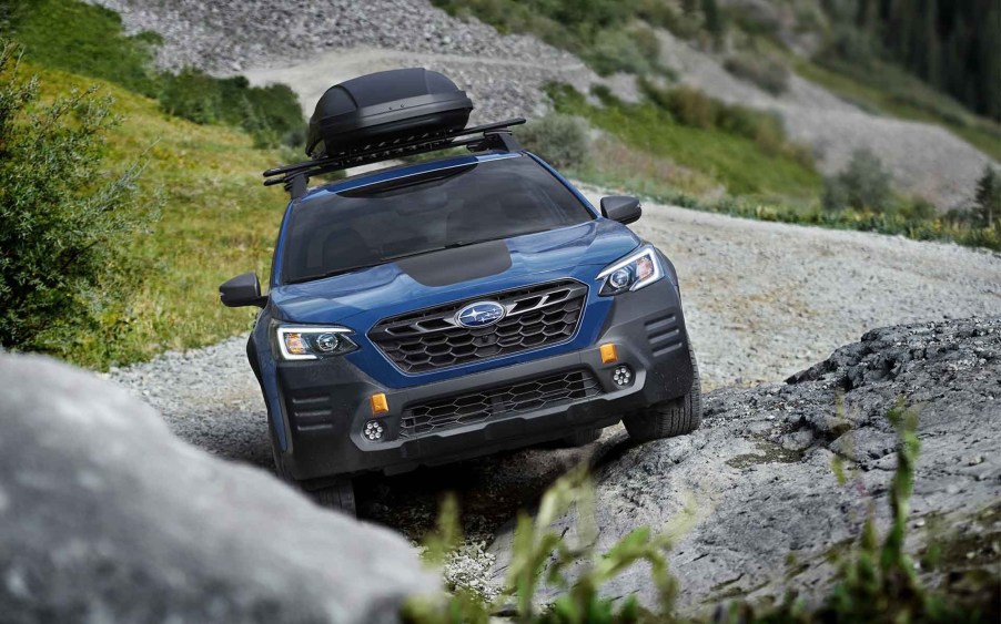 2022 Subaru Outback Wilderness Edition driving up a craggy rock