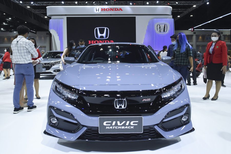 People look at gray Honda Civic cars during at the 42nd Bangkok International Motor Show 2021 in Bangkok, Thailand