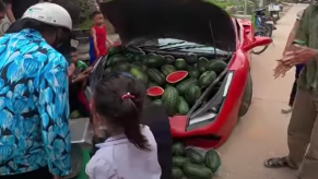 Phony Ferrari trunk open with melons for sale