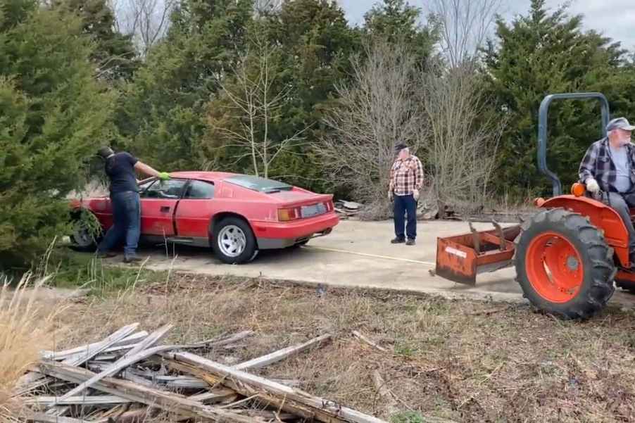 a 1988 Lotus Esprit barn find getting pulled out of a field