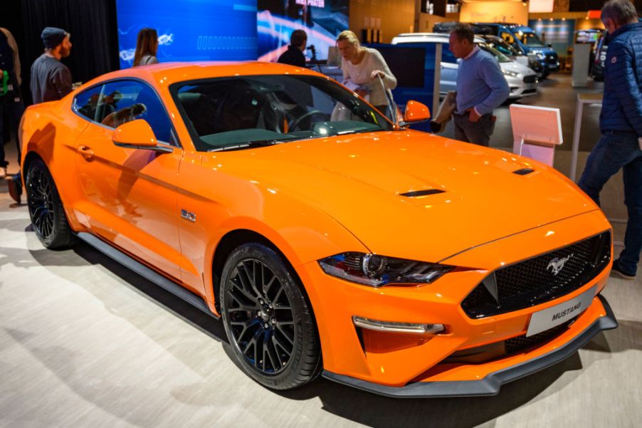 A bright orange Ford Mustang on display