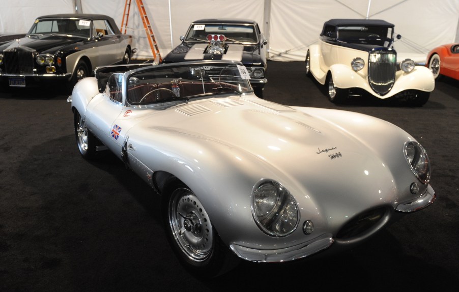 A silver 1957 Jaguar XKSS 3.8-liter replica, valued at $225,000, sits among vintage and classic cars on display