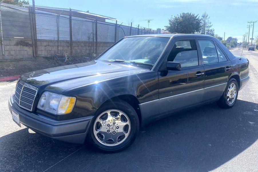 A black 1995 Mercedes-Benz E320 in a sunny street