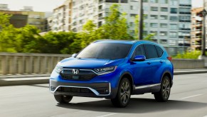 A blue 2021 Honda CR-V Touring driving