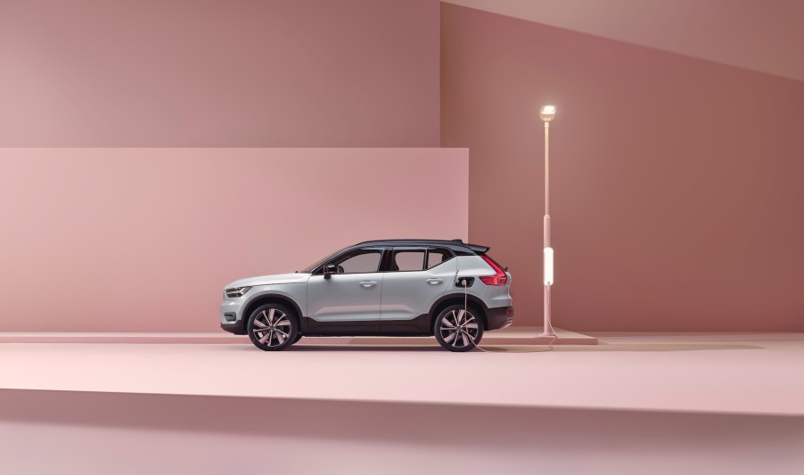 A 2021 Volvo XC40 Recharge P8 all-wheel-drive SUV in Glacier Silver sitting in a pink studio