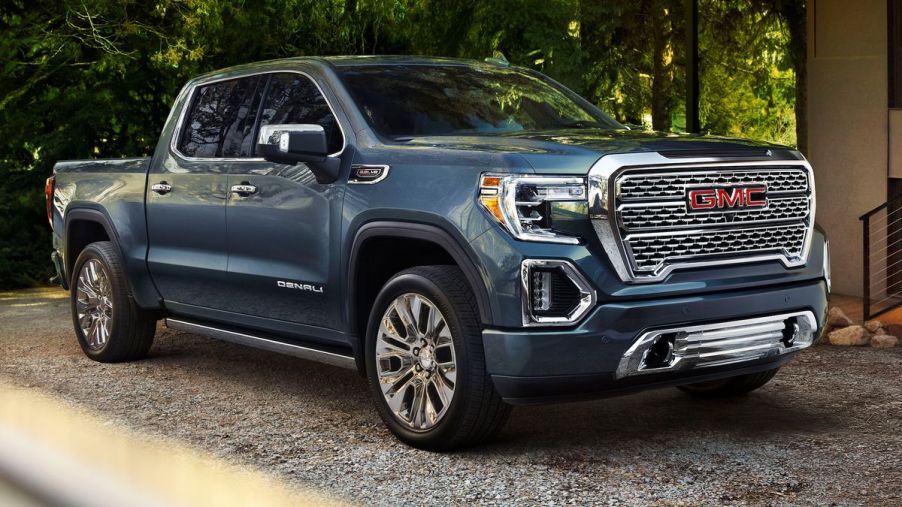 A blue 2021 GMC Sierra parked in the shade.