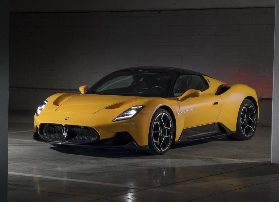 A yellow 2022 Maserati MC20 in a garage