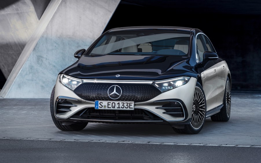 A silver and black 2022 Mercedes-Benz EQS electric sedan parked in a gray showroom