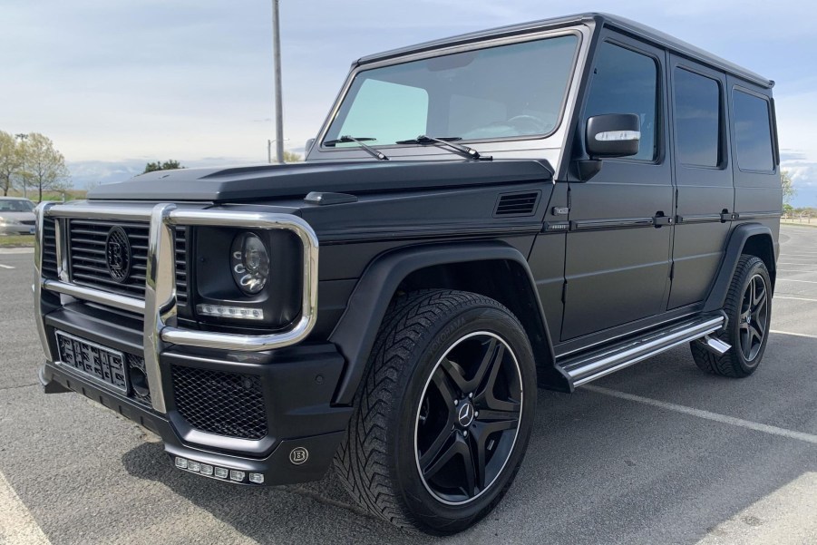 A modified matte-black 1995 Mercedes-Benz G320 in a parking lot