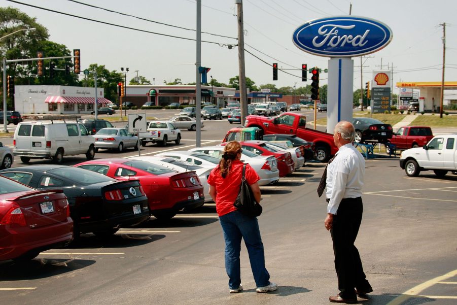 A saleman helps out a customer at a Ford dealership August 3, 2009 in Downers Grove, Illinois.