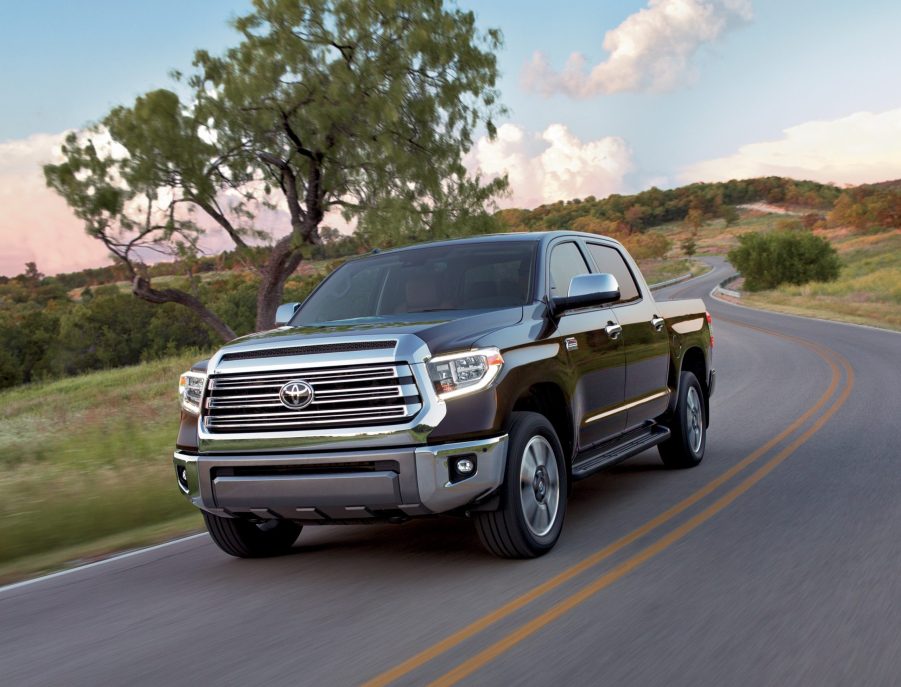 A brown Toyota Tundra rolls down a country road