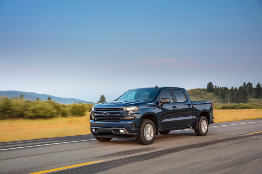 A dark blue 2021 Chevrolet Silverado RST driving, the Silverado is one of the best new diesel trucks