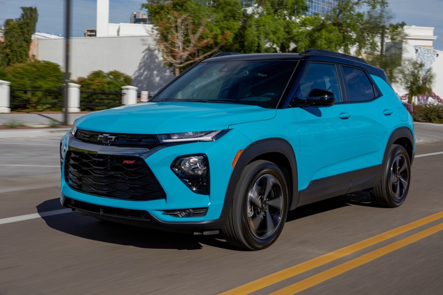 A bright-blue 2021 Chevrolet Trailblazer RS compact SUV traveling on a city road on a sunny day