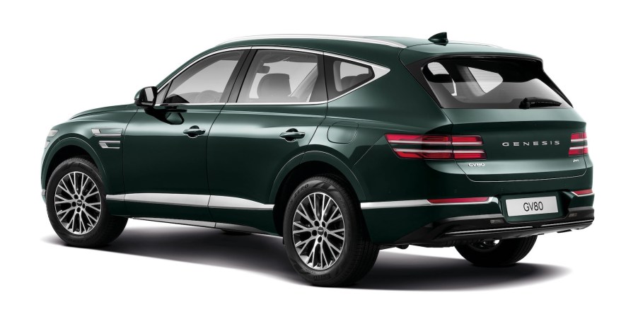 A dark-green 2021 Genesis GV80 luxury midsize SUV on a white background