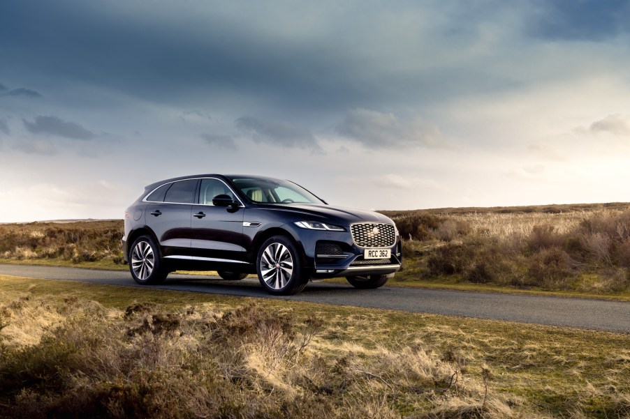 A navy-blue 2021 Jaguar F-Pace PHEV luxury compact SUV parked on a rural road