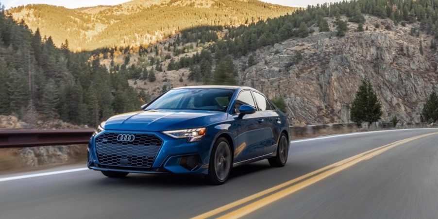 A blue 2022 Audi A3 sedan is driving on the road.