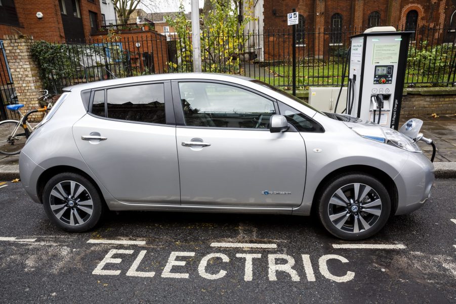 A silver Nissan Leaf EV charging