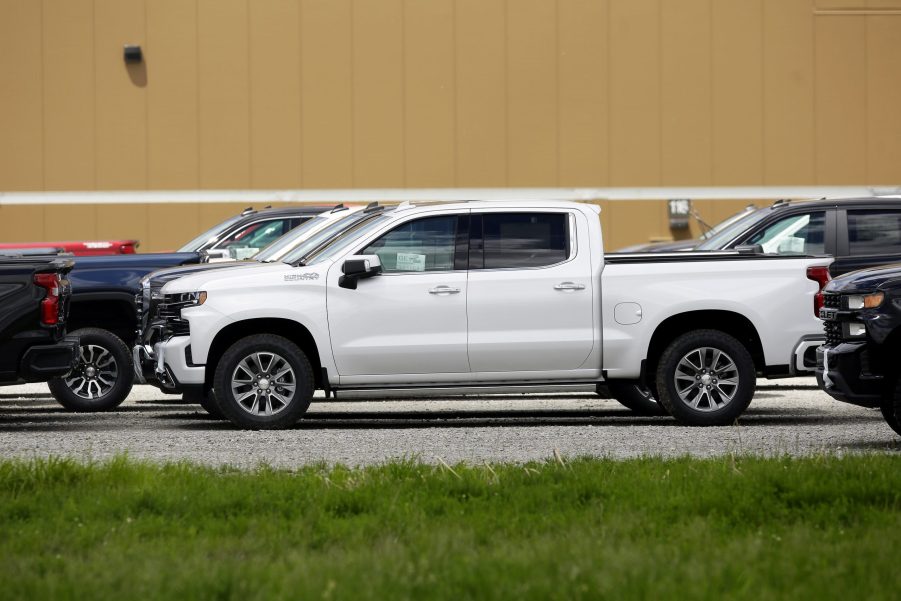 Several pickup trucks on a back lot