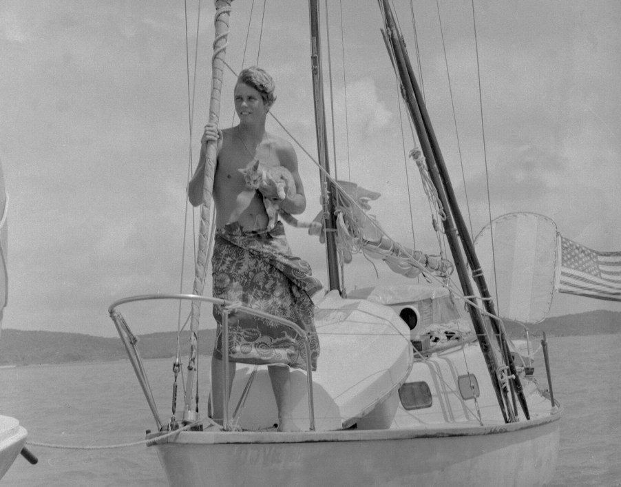 Boating alone, Robin Lee Graham, 18, holds his ginger tabby cat, Avanga, aboard his 24-foot sloop in 1967