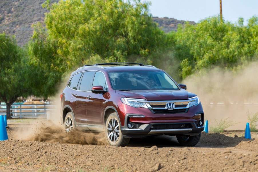 honda pilot driving through dirt