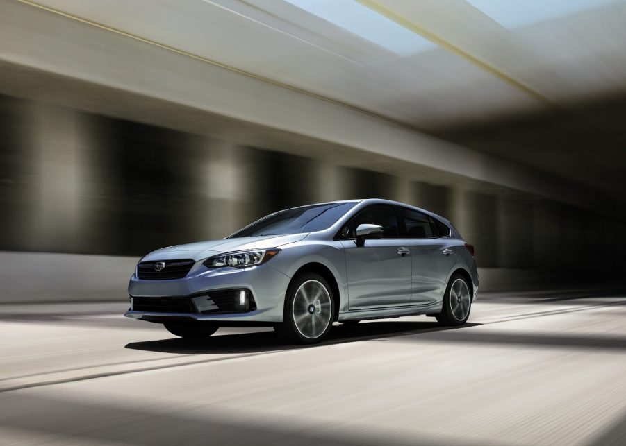 The Subaru Impreza in silver, photographed driving through an underpass