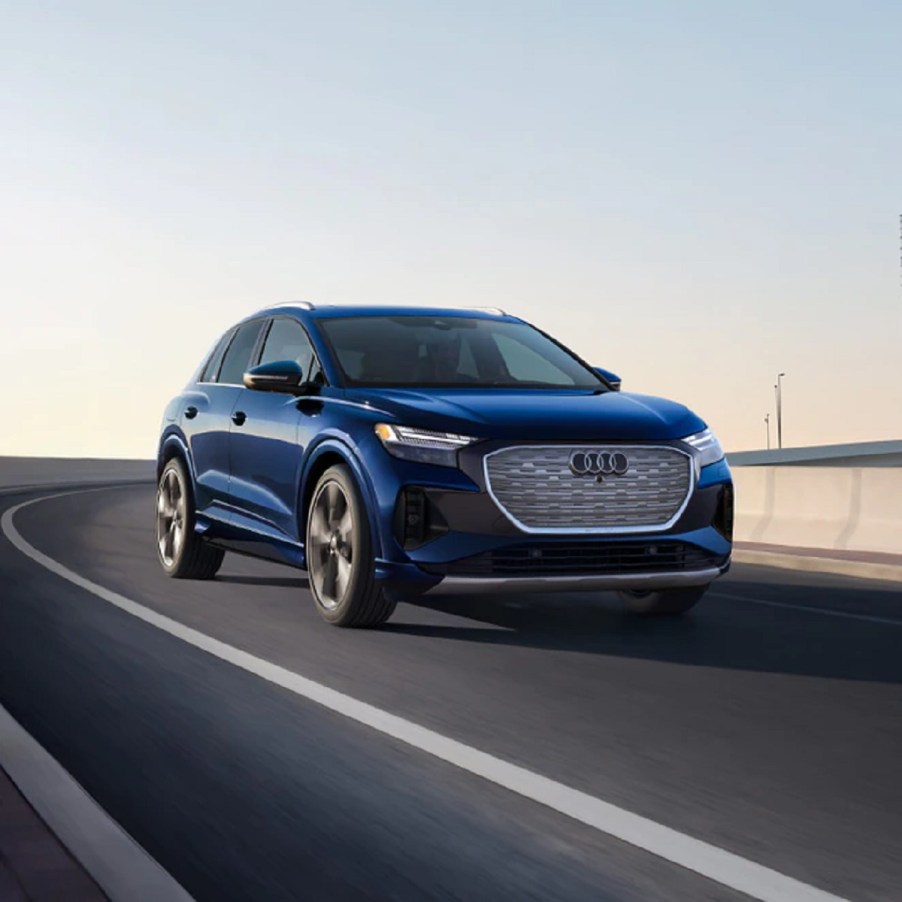 A blue 2021 Audi e-Tron driving down a road.