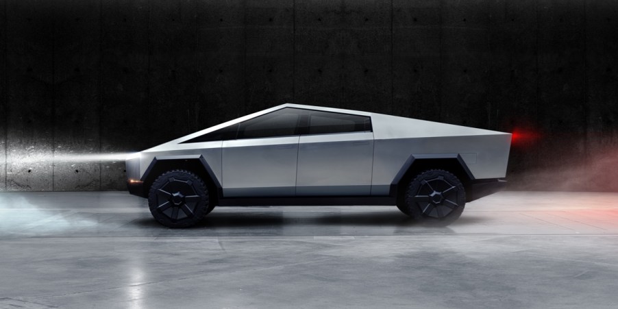 A silver Tesla Cybertruck against a black and smoky background.