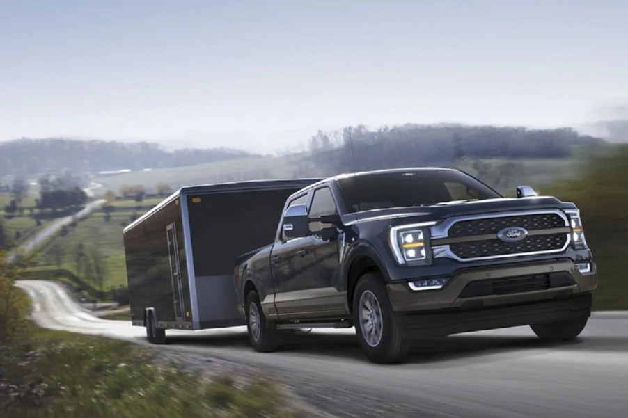 A 2021 Ford F-150 pulling a trailer up a hill.