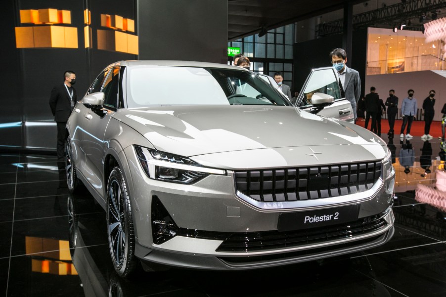 Visitors look at a 2021 Polestar 2 electric car during Auto Shanghai in April 2021 in Shanghai, China