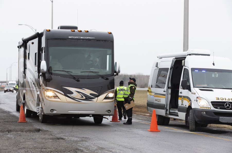 Police officers stop an RV at a checkpoint on the Quebec-Ontario border in Canada in April 2020